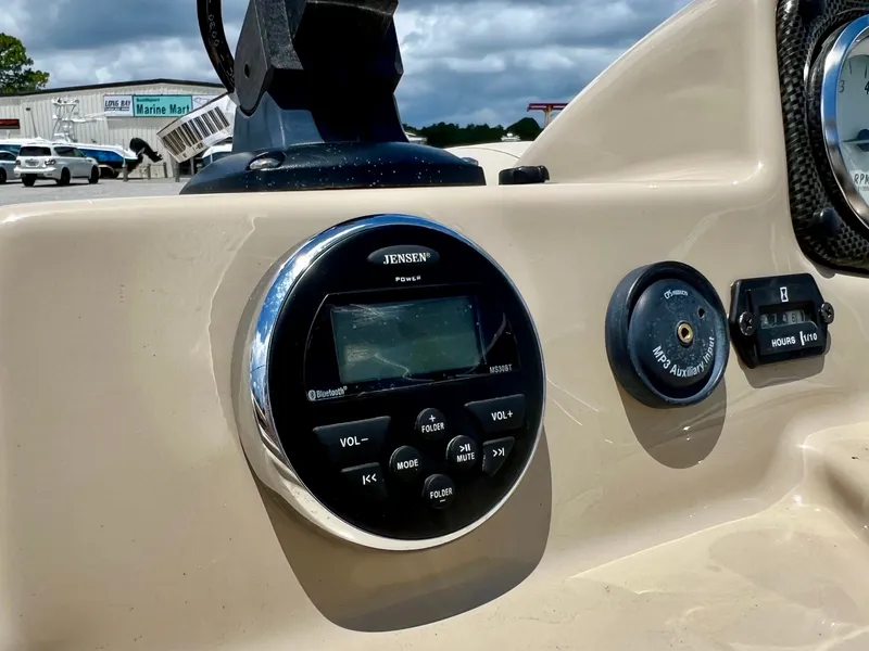 Slide: The Image of Close-up of a boat dashboard featuring a Jensen audio system and controls. - 42