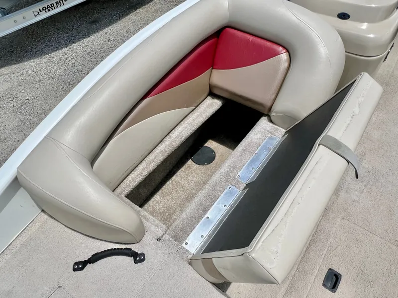 Slide: The Image of The image shows a beige and red boat seat with an open storage compartment underneath. - 29