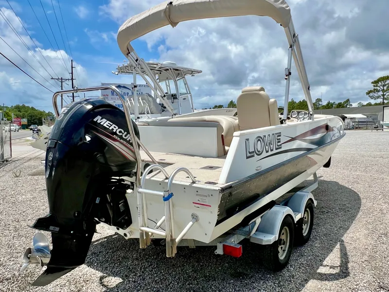Slide: The Image of A 2016 Lowe Sport Deck 224 boat on a trailer. It features a Mercury outboard motor. - 4