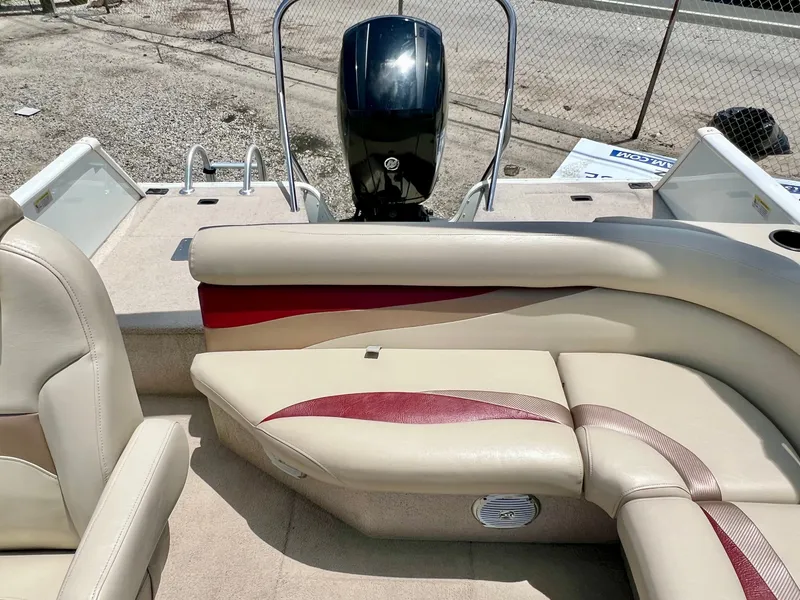 Slide: The Image of The image shows the rear of a 2016 Lowe Sport Deck 224 boat with an outboard motor and beige seating. - 21