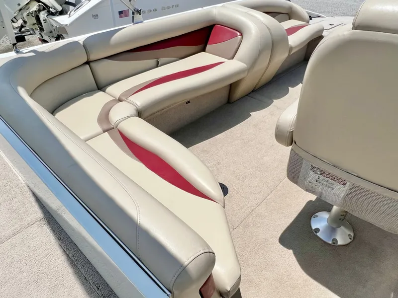 Slide: The Image of The image shows the beige and red upholstery of a 2016 Lowe Sport Deck 224. - 19