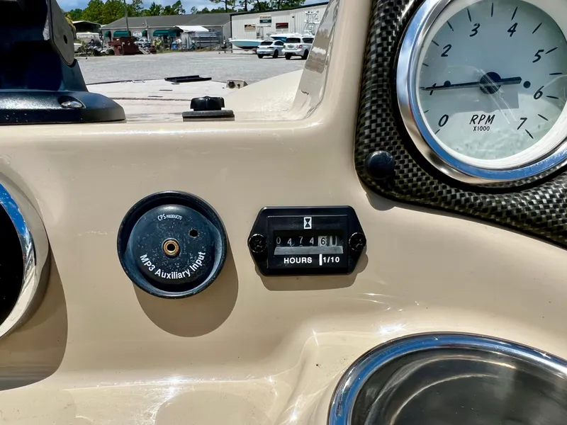 Slide: The Image of Close-up of a boat dashboard with a tachometer and hour meter. - 43