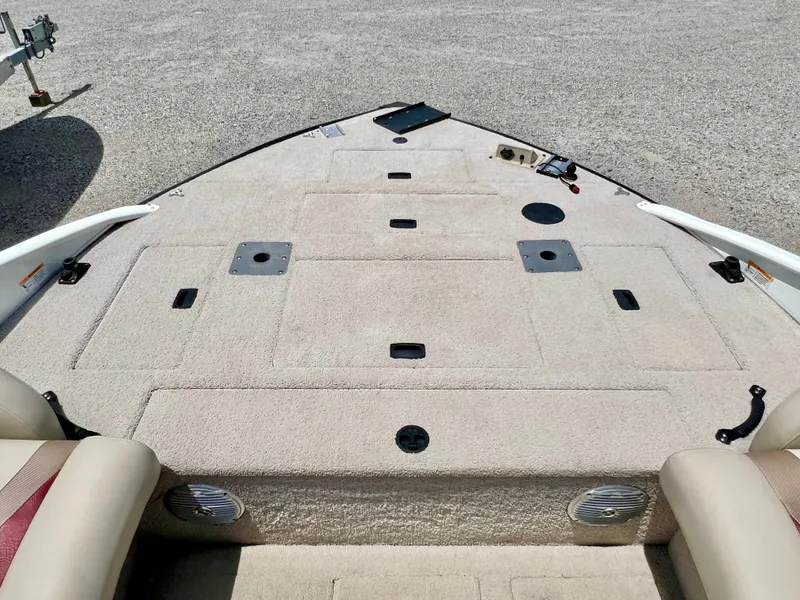 Slide: The Image of The image shows the bow deck of a 2016 Lowe Sport Deck 224 boat with beige carpeting. - 32
