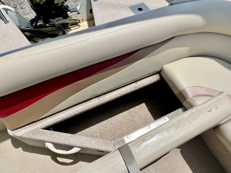 Slide: The Image of The image shows a beige seat with red accents on a boat. The floor is carpeted. - 22