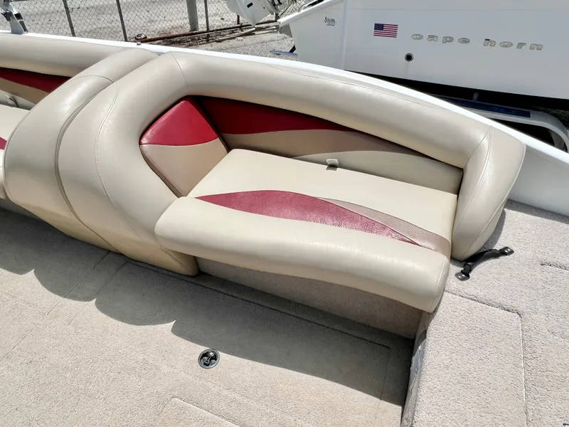 Slide: The Image of The image shows a beige and red bench seat on a boat, surrounded by carpeted flooring. - 28