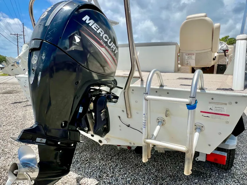 Slide: The Image of A 2016 Lowe Sport Deck 224 with a Mercury outboard motor and swim ladder at the stern. - 11