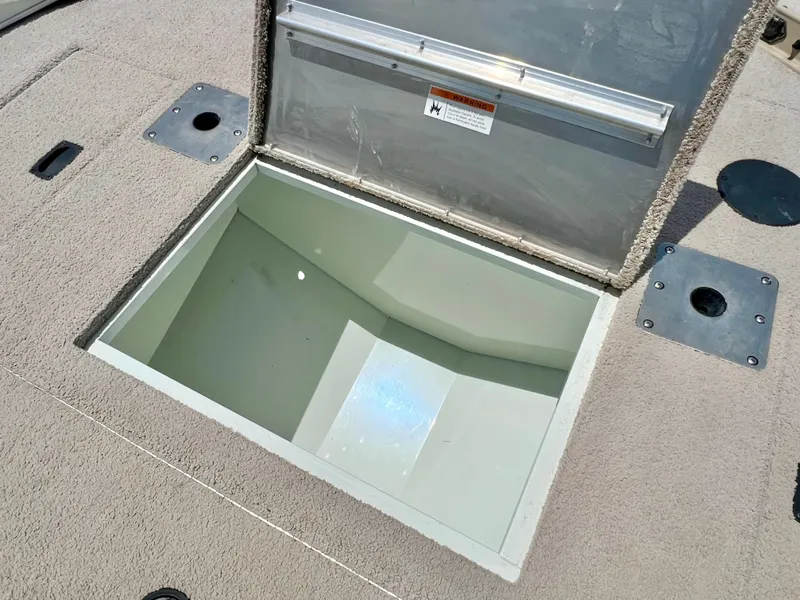 Slide: The Image of An open storage compartment on the deck of a 2016 Lowe Sport Deck 224 boat. - 35