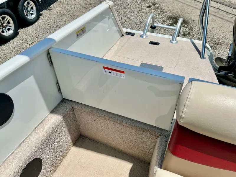 Slide: The Image of The image shows the rear of a 2016 Lowe Sport Deck 224 boat with a swim ladder. - 12