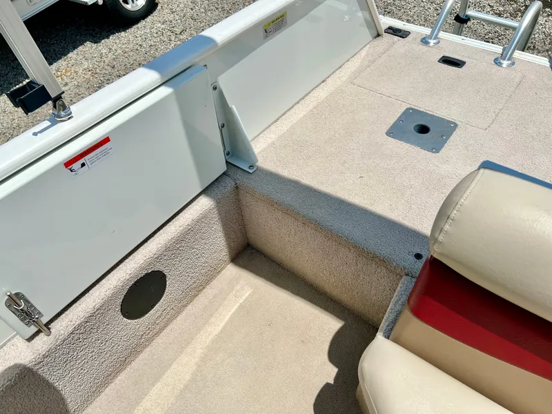 Slide: The Image of The image shows the deck of a 2016 Lowe Sport Deck 224 boat with beige carpeting. - 13
