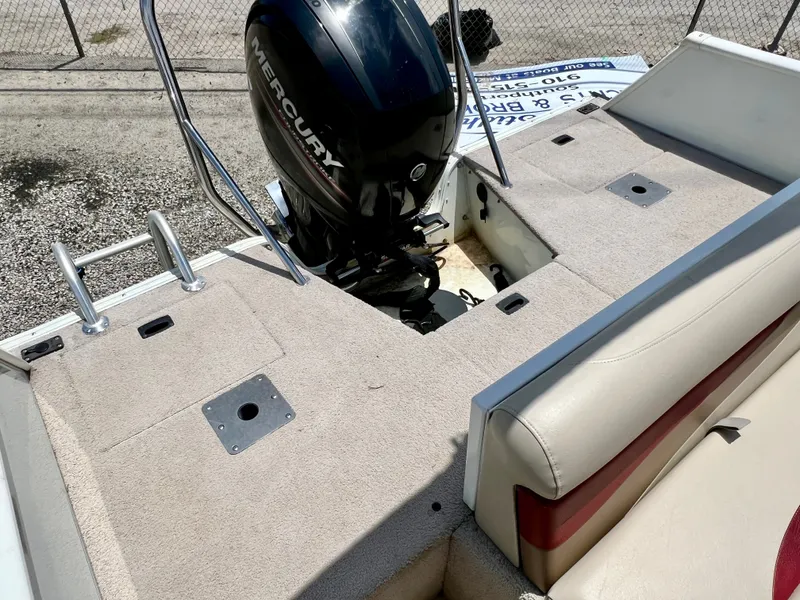 Slide: The Image of The image shows the rear of a 2016 Lowe Sport Deck 224 boat with a Mercury outboard motor. - 14