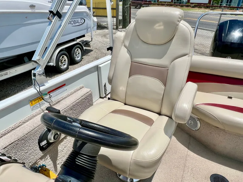 Slide: The Image of The interior of a 2016 Lowe Sport Deck 224 features a beige captain's chair and steering wheel. - 38