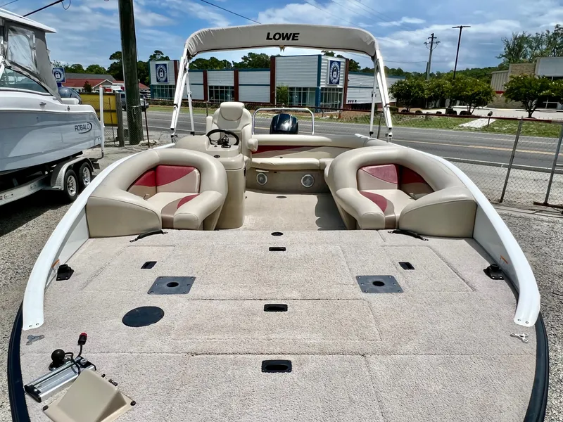 Slide: The Image of The image shows a 2016 Lowe Sport Deck 224 boat with a spacious deck and comfortable seating. - 25