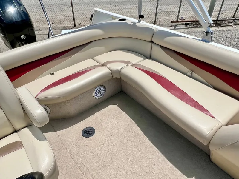 Slide: The Image of The image shows the beige and red seating area of a 2016 Lowe Sport Deck 224 boat. - 20