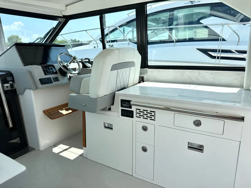 Slide: The Image of Interior of a 2023 Regal 36 XO with a modern helm and comfortable seating area. - 22