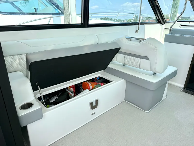 Slide: The Image of The 2023 Regal 36 XO features an elegant seating area with storage underneath. - 21