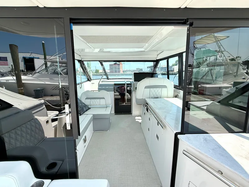 Slide: The Image of The image shows the interior of a 2023 Regal 36 XO with sleek seating and modern amenities. - 16