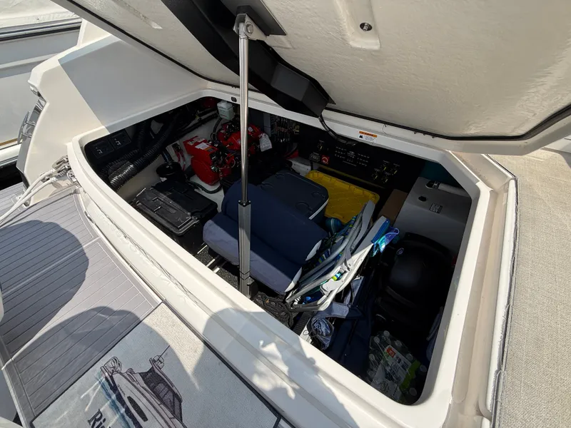 Slide: The Image of Storage compartment at the stern of a Regal 36 XO boat, filled with gear and accessories. - 47