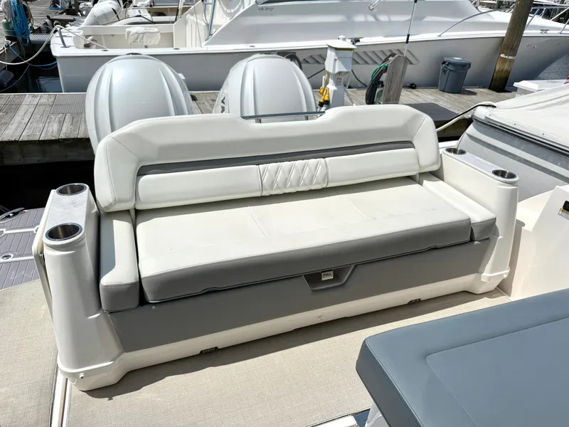 Slide: The Image of The 2023 Regal 36 XO features an elegant outdoor cushioned bench with cup holders. - 8