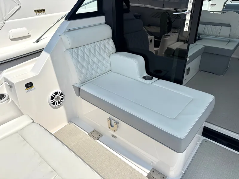 Slide: The Image of The 2023 Regal 36 XO features an elegant white bench seat with diamond stitching and a cup holder. - 12