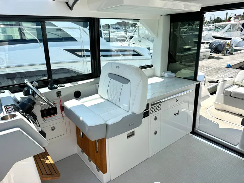 Slide: The Image of The image shows the cockpit of a 2023 Regal 36 XO with a white seat and helm. - 24