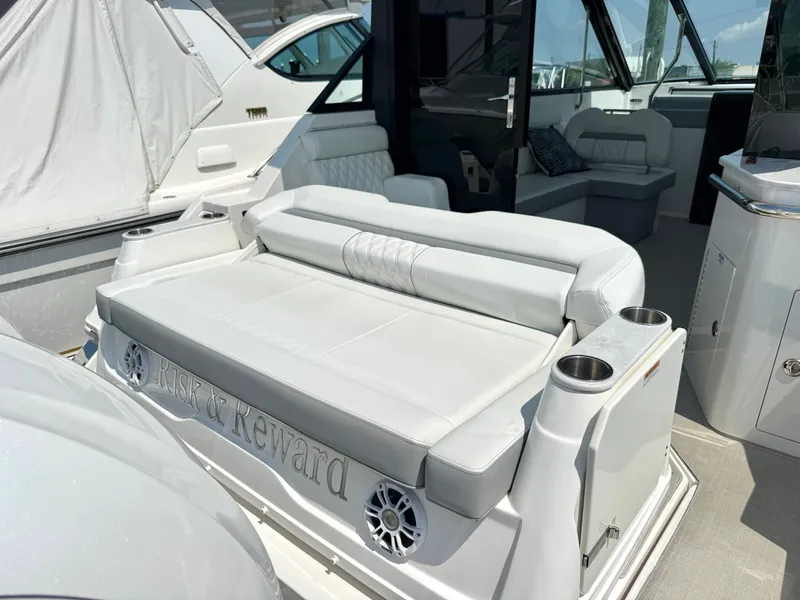 Slide: The Image of The 2023 Regal 36 XO features a luxurious bench seat with integrated speakers and cup holders. - 11