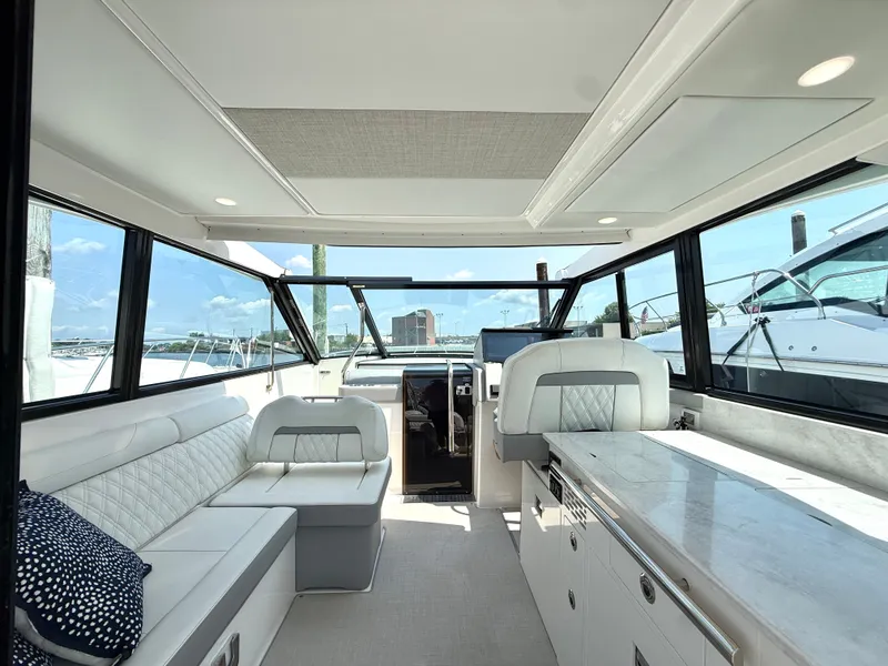 Slide: The Image of The image shows the interior of a 2023 Regal 36 XO with sleek seating and modern design. - 18