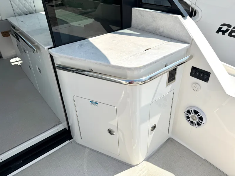 Slide: The Image of The 2023 Regal 36 XO features a sleek outdoor kitchen with a marble countertop and speaker. - 14