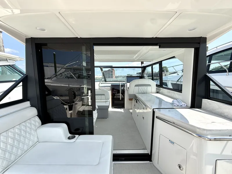 Slide: The Image of The image shows the cockpit of a 2023 Regal 36 XO with luxurious white seating. - 7