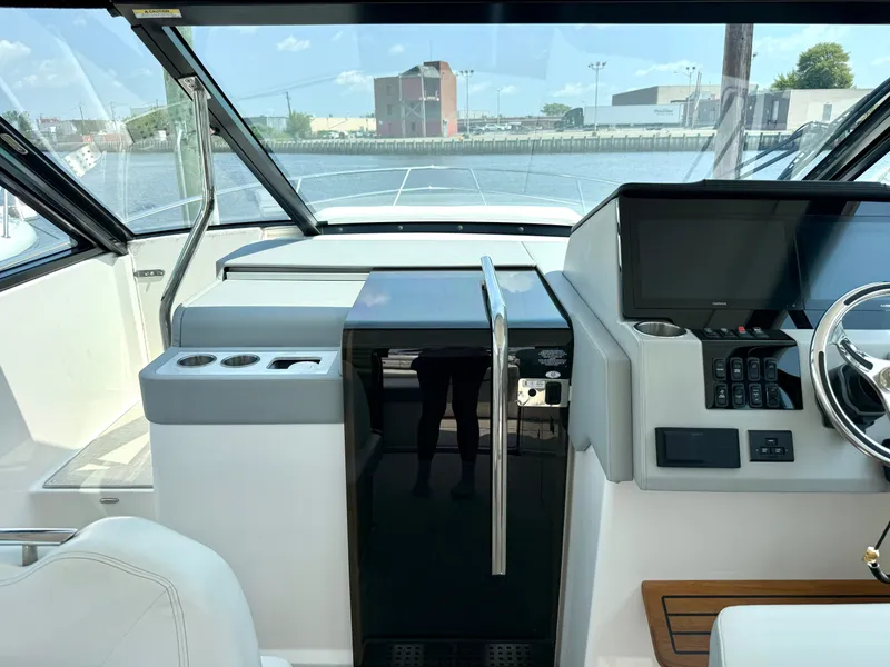 Slide: The Image of The cockpit of the 2023 Regal 36 XO features a modern helm with a large display screen. - 30