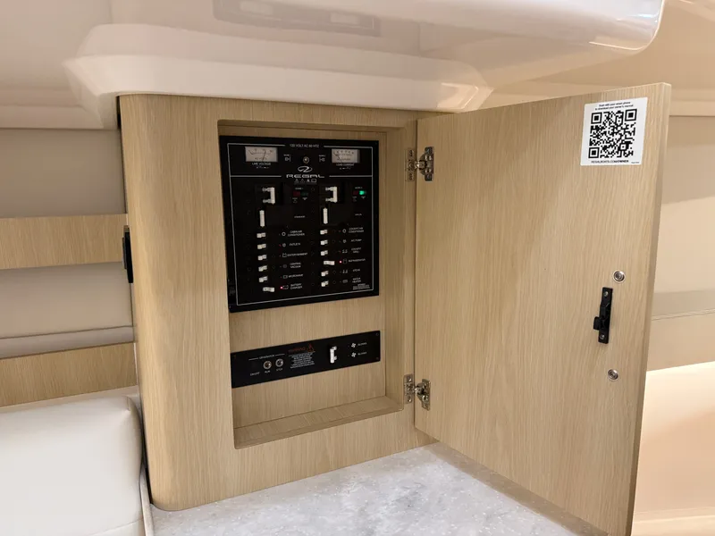 Slide: The Image of An open wooden cabinet reveals an electrical panel with switches and gauges. - 40