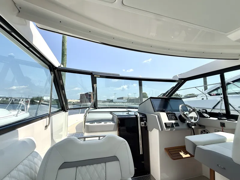 Slide: The Image of The cockpit of the 2023 Regal 36 XO features modern seating and a sleek dashboard. - 28
