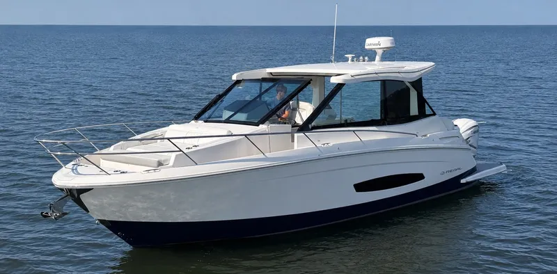 Slide: The Image of A sleek white boat on calm water, featuring a modern design and enclosed cockpit. - 3