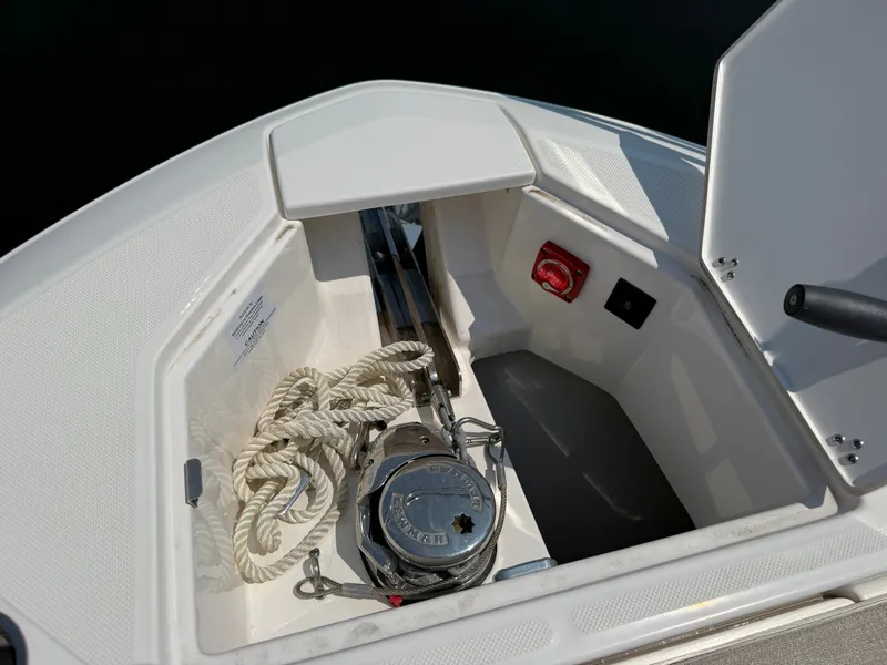 Slide: The Image of The bow of a 2023 Regal 36 XO features an anchor and ropes in the storage compartment. - 46