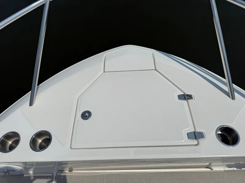 Slide: The Image of The bow of a 2023 Regal 36 XO boat with stainless steel railing and cup holders. - 45