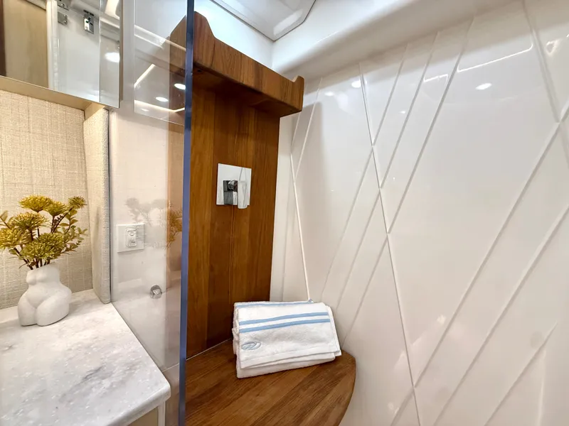 Slide: The Image of Elegant bathroom with wood and marble details, towels, and decorative plants. - 39