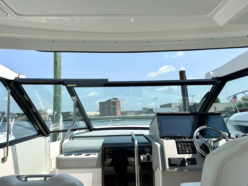 Slide: The Image of The cockpit of a 2023 Regal 36 XO with a modern helm and panoramic view. - 29
