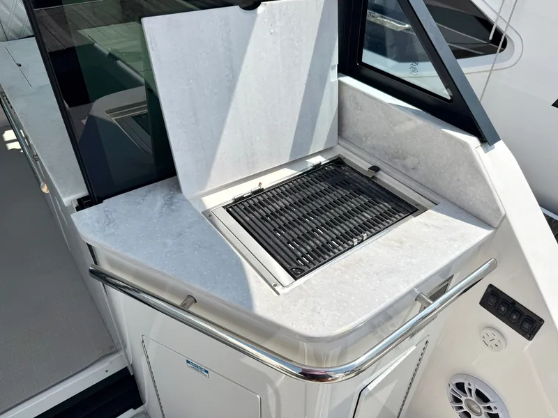 Slide: The Image of The 2023 Regal 36 XO features a built-in grill on the aft deck. - 15