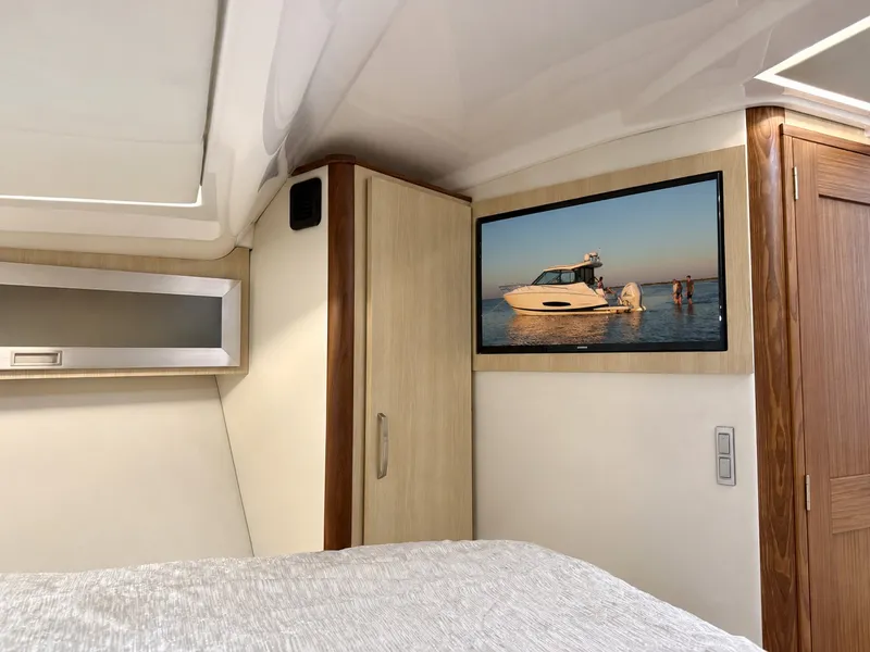 Slide: The Image of The interior of a 2023 Regal 36 XO features a sleek bedroom with a built-in television. - 32