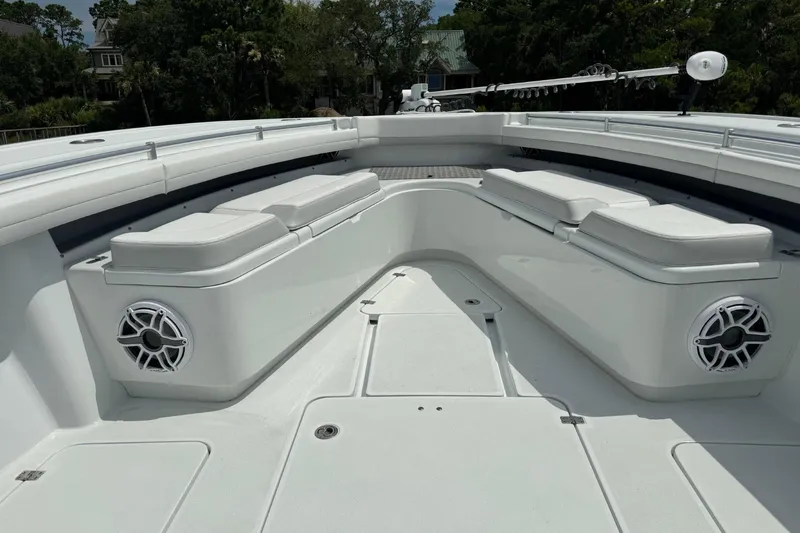 Slide: The Image of 2024 Yellowfin 39 Offshore boat interior with cushioned seating and speakers. - 6