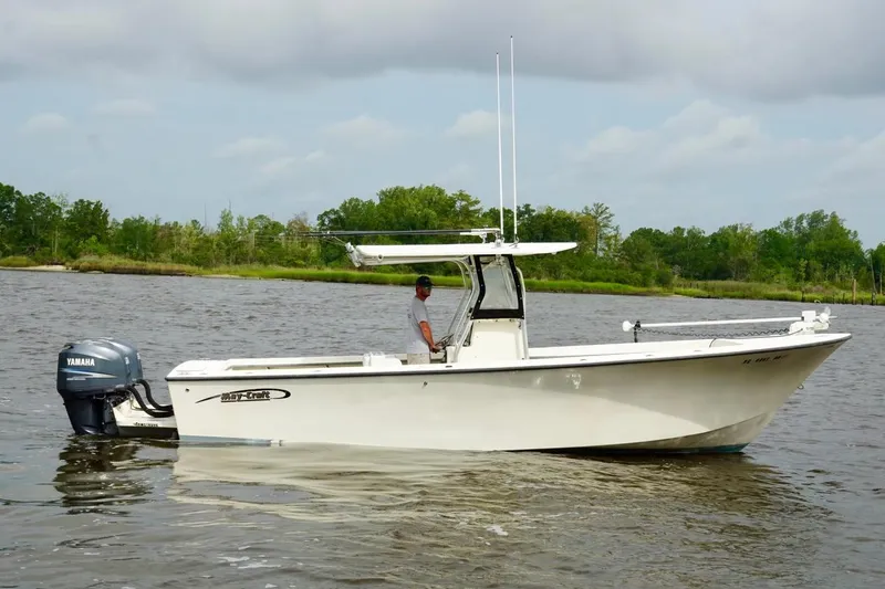 The Image of 2009 May-Craft 2700CCX boat on calm water with Yamaha outboard motor. - 0