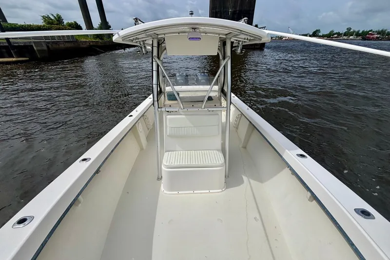 Slide: The Image of 2009 May-Craft 2700CCX boat on water, featuring spacious deck and center console. - 16