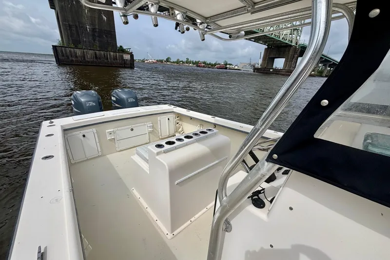 Slide: The Image of 2009 May-Craft 2700CCX boat on water near bridge, featuring dual engines. - 12
