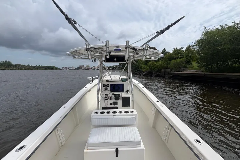 Slide: The Image of 2009 May-Craft 2700CCX boat on a river, featuring a center console and fishing equipment. - 10