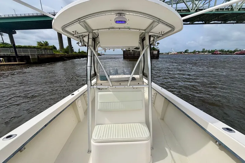 Slide: The Image of 2009 May-Craft 2700CCX boat on water under a bridge, showcasing center console design. - 14
