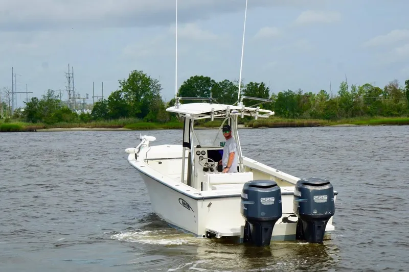 Slide: The Image of 2009 May-Craft 2700CCX boat with dual Yamaha engines cruising on a river. - 1