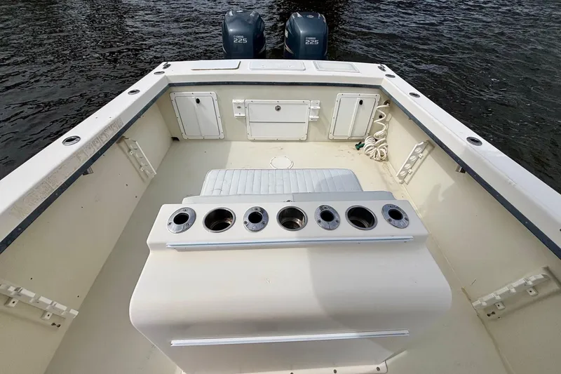 Slide: The Image of 2009 May-Craft 2700CCX boat interior with rod holders and twin Yamaha 225 engines. - 11