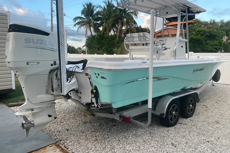 Slide: The Image of 2020 Blue Wave 2600 PureBay boat with Suzuki outboard motor on trailer. - 2