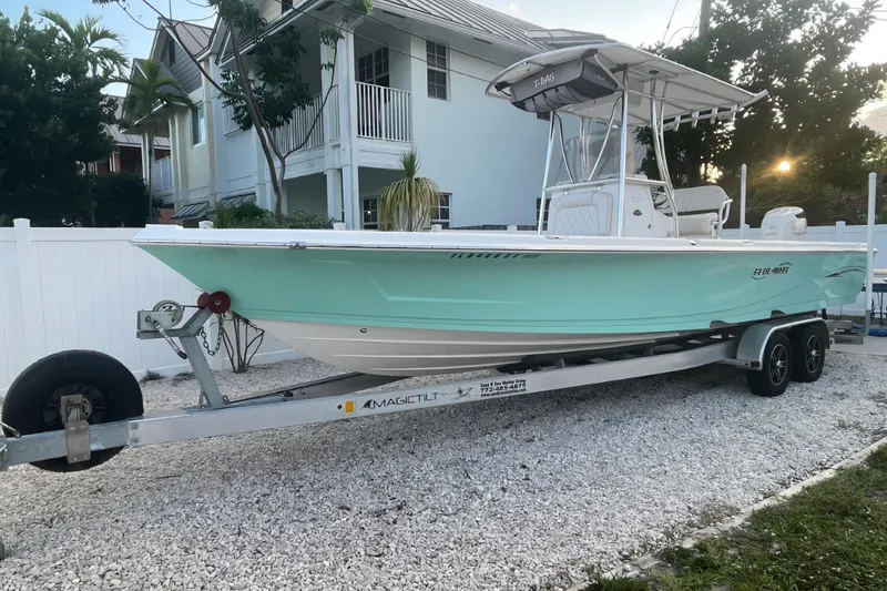 Slide: The Image of 2020 Blue Wave 2600 PureBay boat on trailer, parked in residential area. - 1