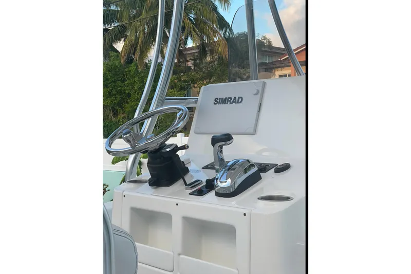 Slide: The Image of 2020 Blue Wave 2600 PureBay boat console with steering wheel and Simrad display. - 8