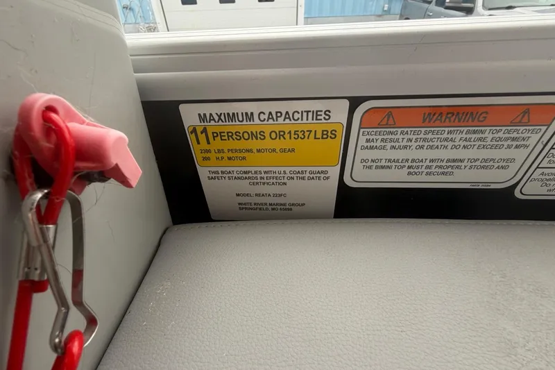 Slide: The Image of 2021 Ranger Reata 223FC capacity label, maximum 11 persons or 1537 lbs, safety warnings included. - 16